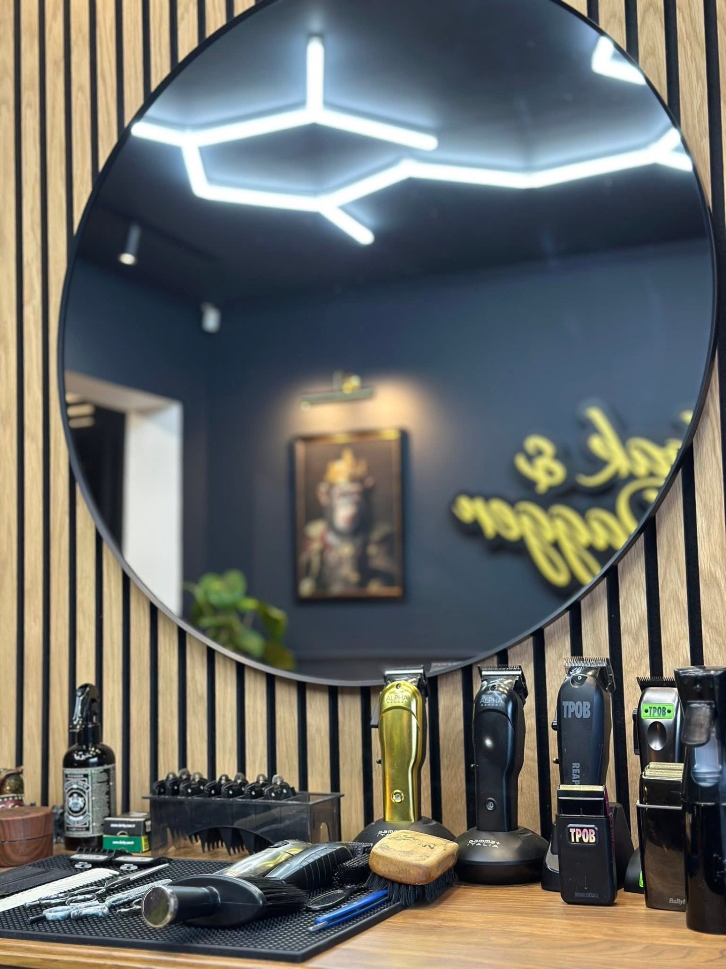 Round barber mirror reflecting hexagonal LED ceiling lights