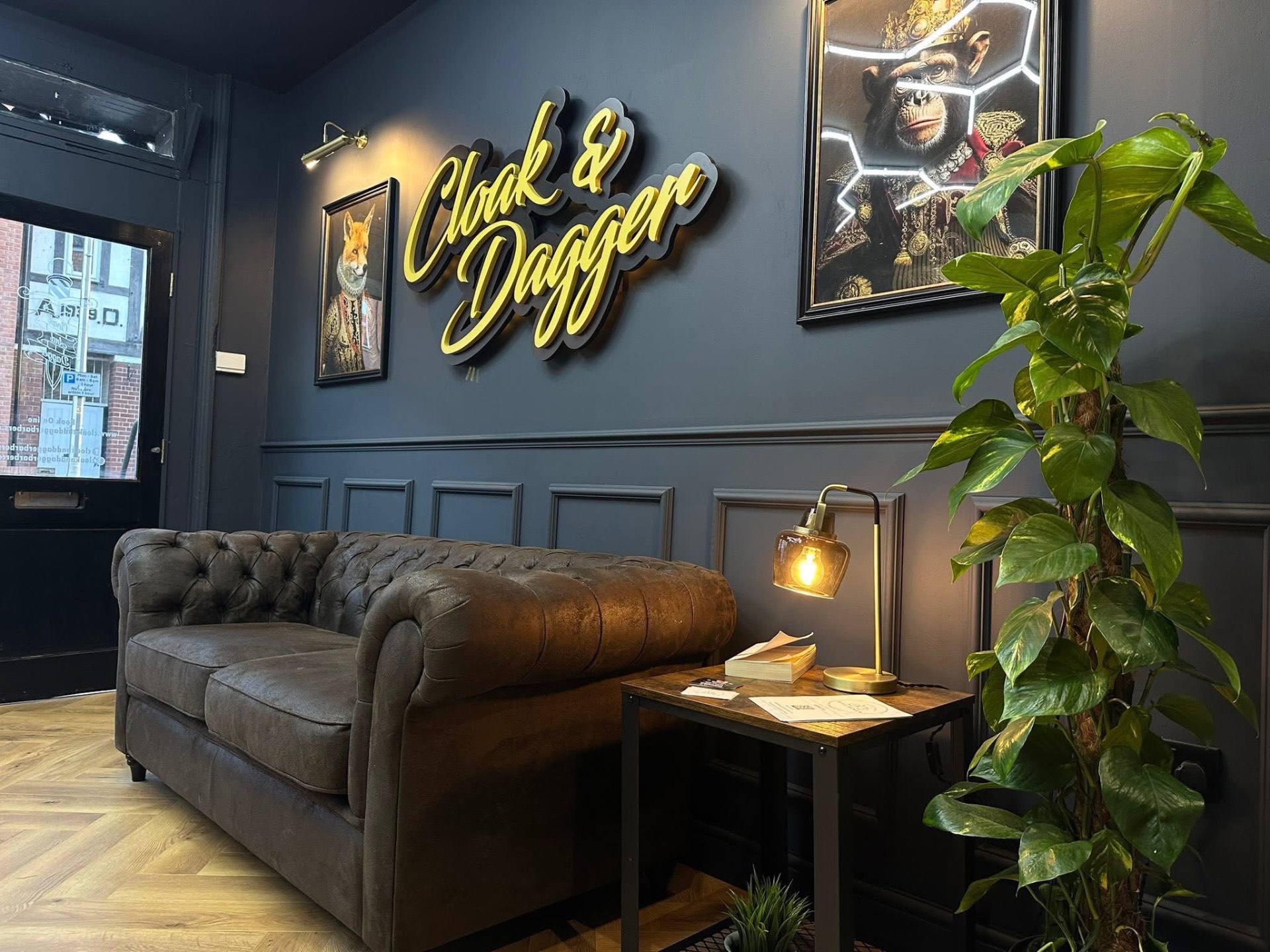Cloak & Dagger barbershop lounge with neon sign and picture lights